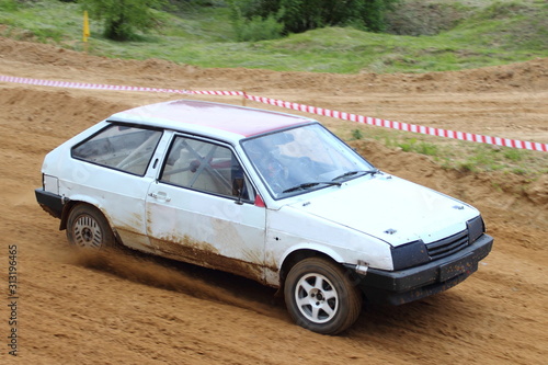 Russian front wheel drive white racing car on off road race close up, auto cross competition