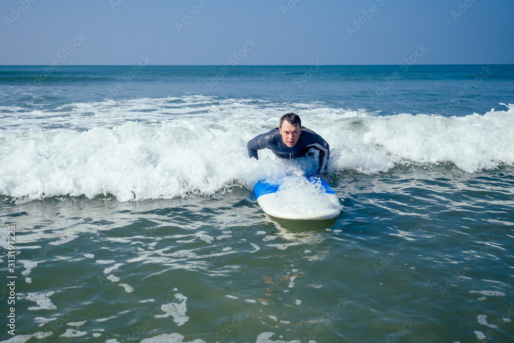 surf instructor showing how riding on big waves in Goa India surf instructor showing how riding on big waves in Goa India