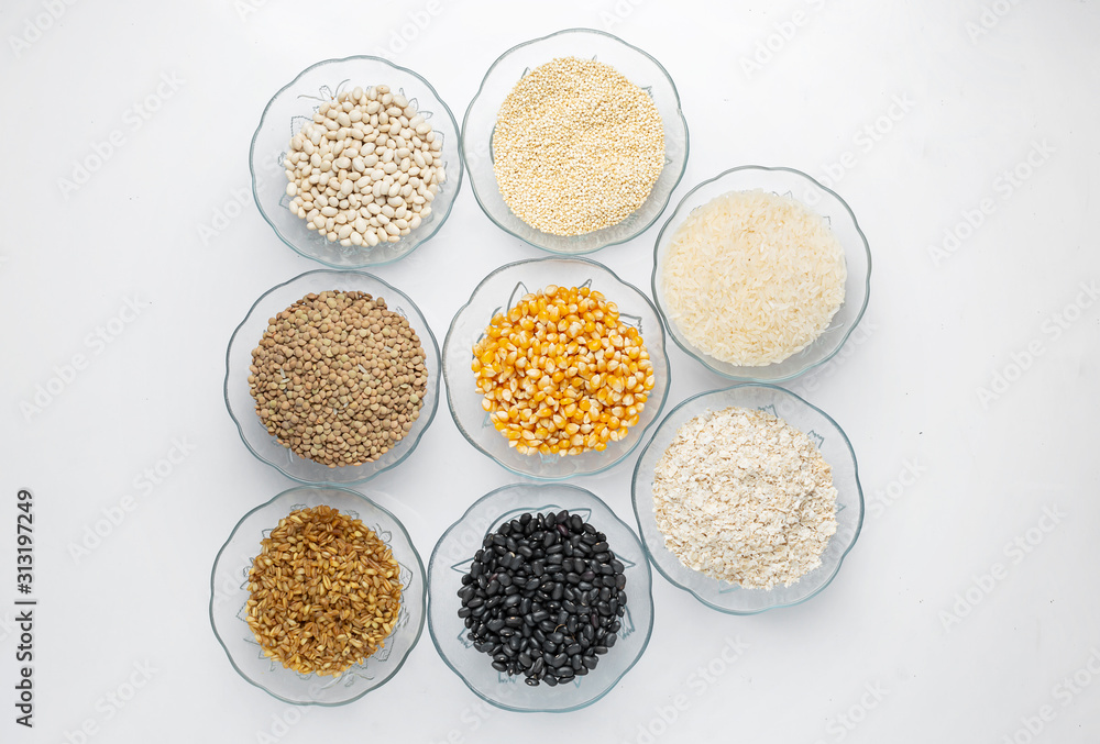 Legumes in glass containers on a table like corn, lentil, rice, oatmeal, beans and quinoa Legumes in glass containers on a table like corn, lentil, rice, oatmeal, beans and quinoa