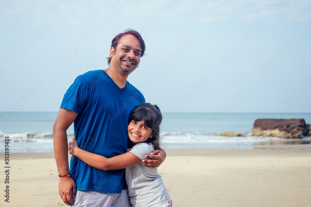 happy daughter and father having fun together in Goa .travel medical insurance concept happy daughter and father having fun together in Goa .travel medical insurance concept