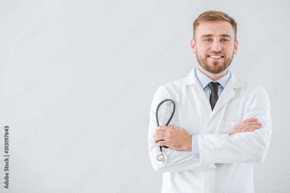 Portrait of male doctor with stethoscope on light background Portrait of male doctor with stethoscope on light background