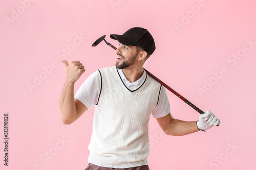 Handsome male golfer pointi...