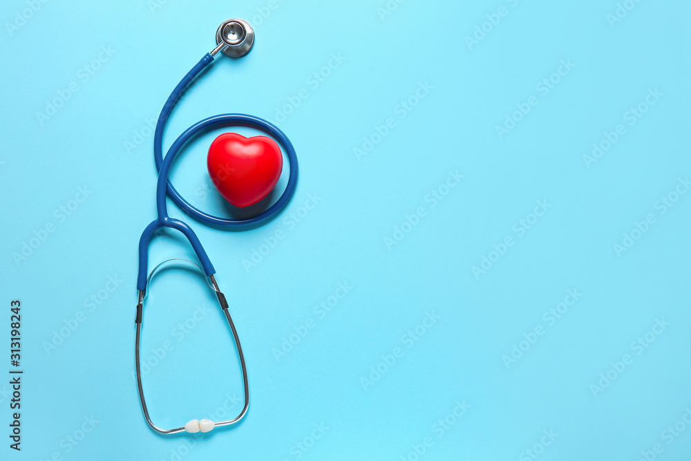 Modern stethoscope and red heart on color background Modern stethoscope and red heart on color background