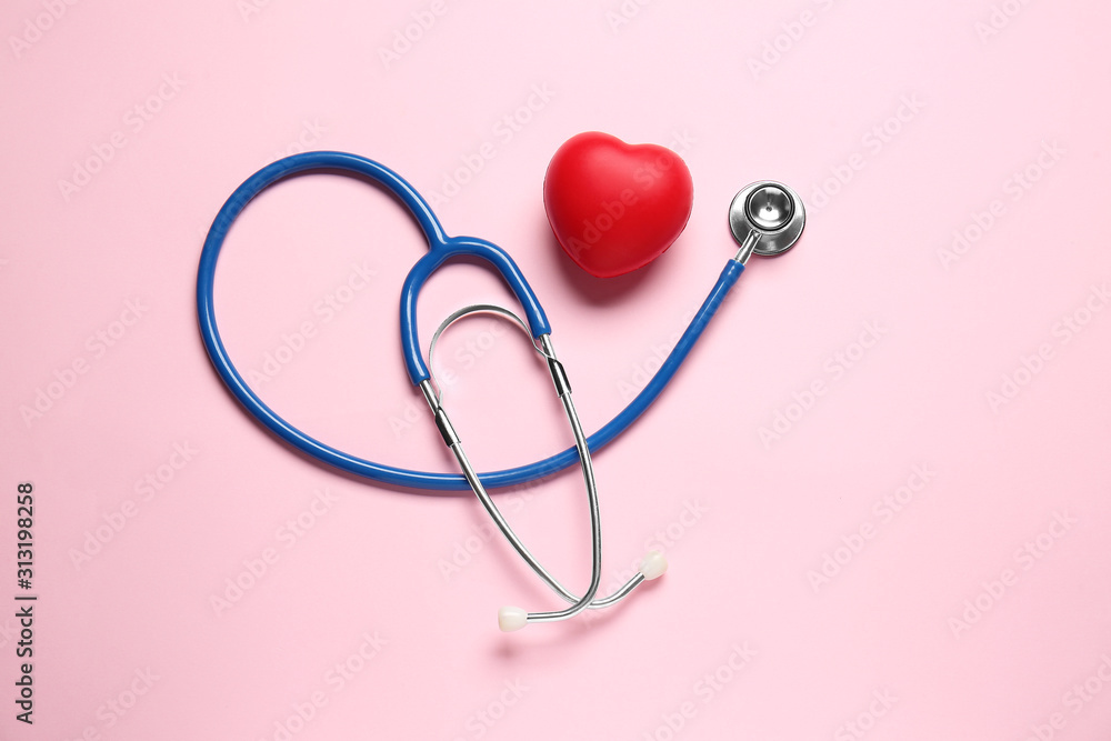 Modern stethoscope and red heart on color background Modern stethoscope and red heart on color background