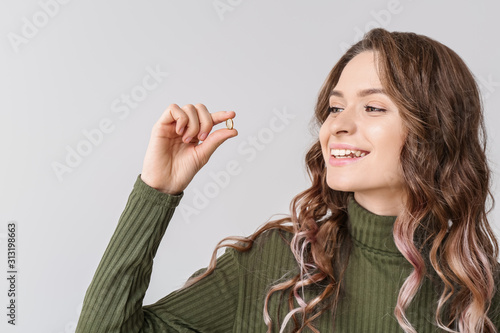 Young woman with fish oil o...