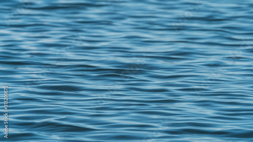 background texture of waves on blue ocean on a sunny day 