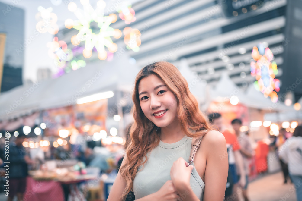 Traveler Asian blogger women travel in Bangkok, Thailand, beautiful female using .Travel vacation at night in the city concept, Young happy traveler asian woman  and backpack walking