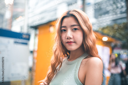 Traveler Asian blogger women travel in Bangkok, Thailand, beautiful female using .Travel vacation at night in the city concept, Young happy traveler asian woman and backpack walking