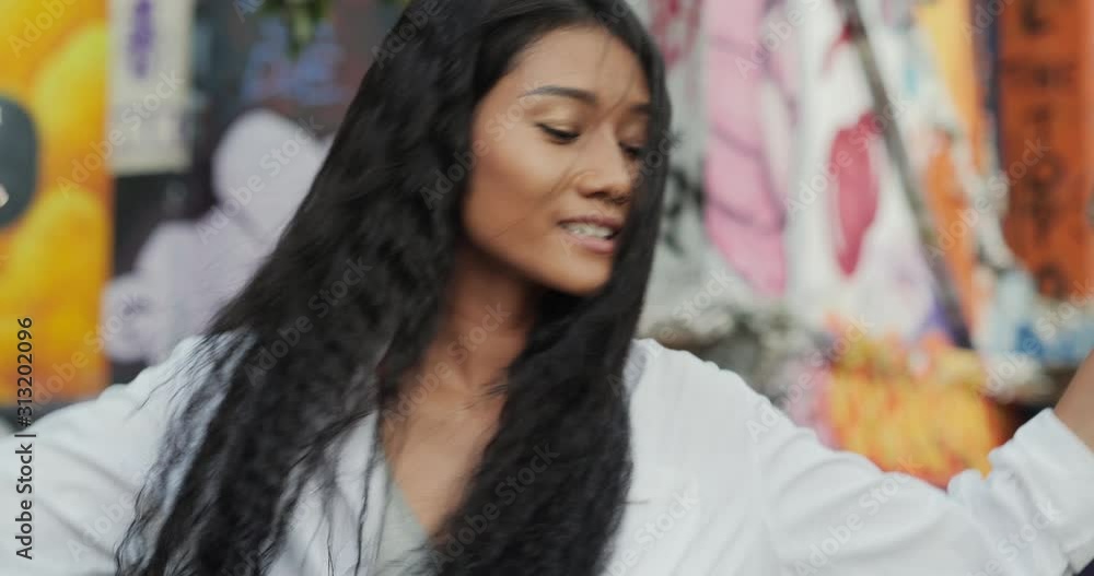 Joyful black young woman dancing alone at the street. Hipster woman dancing with smiling. Joyful black young woman dancing alone at the street. Hipster woman dancing with smiling.