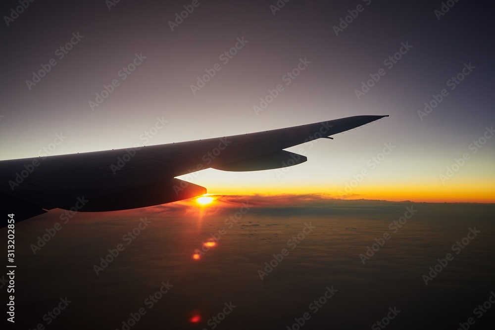 Sunrise and horizon cloudy sky in morning, view from airplane window Sunrise and horizon cloudy sky in morning, view from airplane window