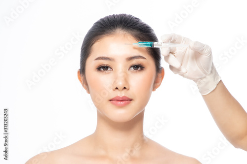 Asain young woman gets injection in her lips. Woman in beauty salon. plastic surgery clinic.Beautiful woman gets injection in her face.