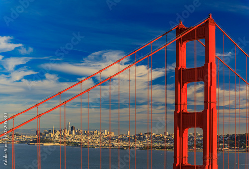 Fototapeta Naklejka Na Ścianę i Meble -  San Francisco skyline through the steel ropes of the famous Golden Gate bridge viewed from Marin Headlands, California