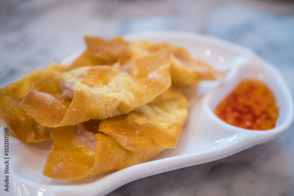 Close-up view of the deep fried pork dumpling with sauce. Close-up view of the deep fried pork dumpling with sauce.