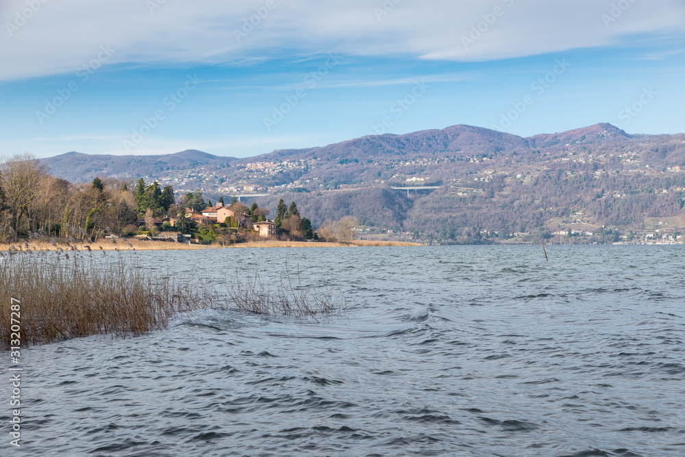 Big European lake in winter. Maggiore lake (lago Maggiore), Italy. Panorama of the Gulf of Quassa and the village of Ranco