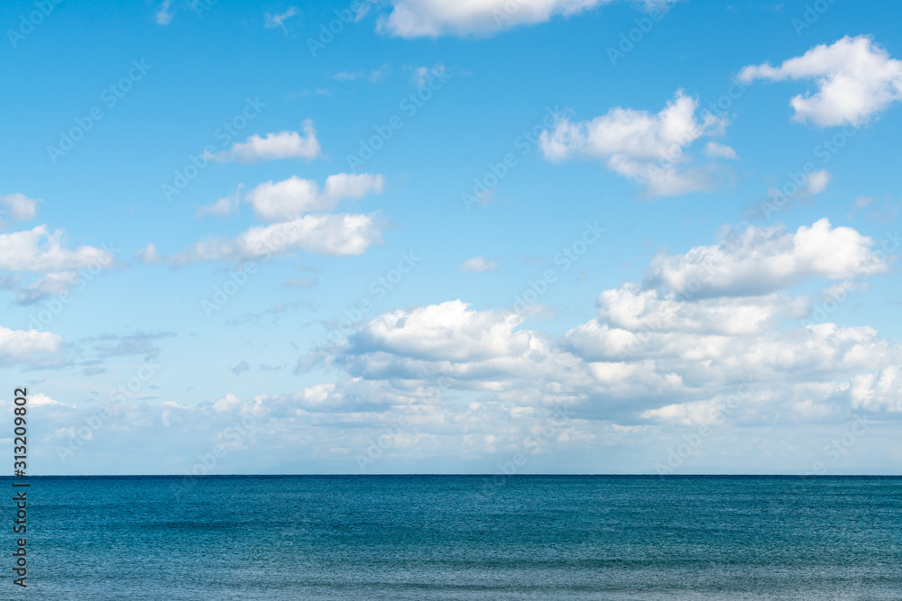Ocean skyline with blue sky and white cloudy, natural landscape background