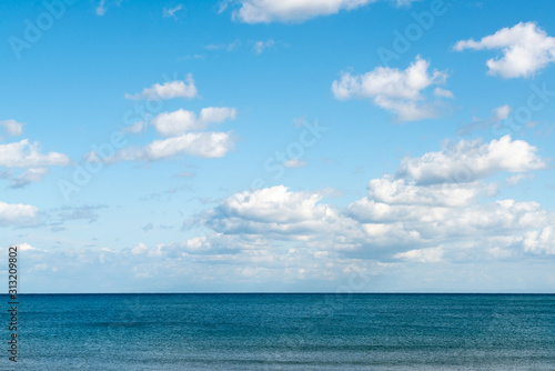 Ocean skyline with blue sky and white cloudy, natural landscape background © pranodhm