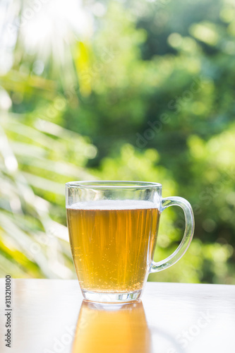 A glass of beer sits on the board.