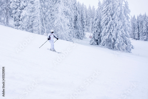 Woman skiing in mountain resort during winter vacation