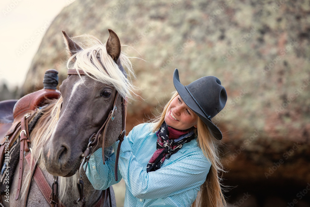 Obraz premium cowgirl with rocky mountain horse