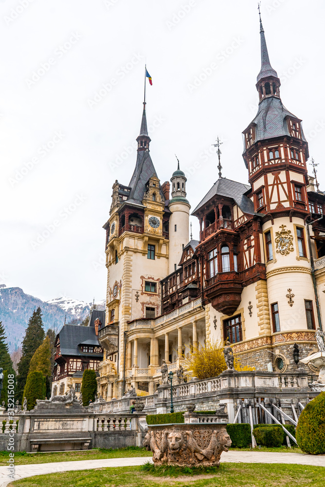 Peles castle and Pelisor castle late morning during spring season . One of the most beautiful classical Art Nouveau castle in Sinaia , Transylvania , Romania