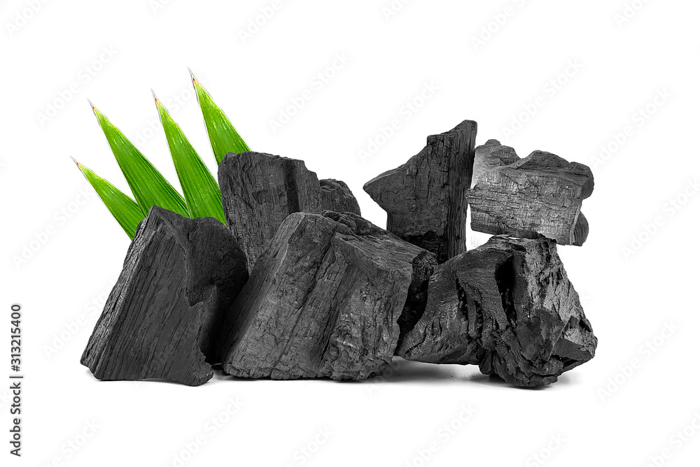 Obraz premium Natural wooden charcoal, Traditional or hard wood charcoal with bamboo leaves isolated on white background.