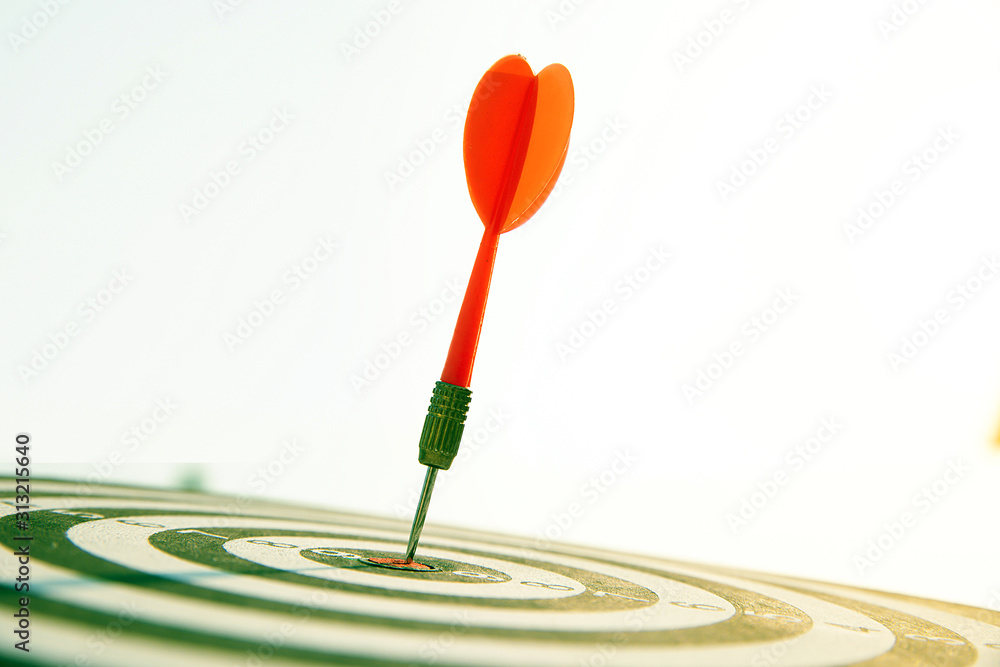 Close up red color arrow in the center of Bullseye concept of business goal and capability. Close up red color arrow in the center of Bullseye concept of business goal and capability.