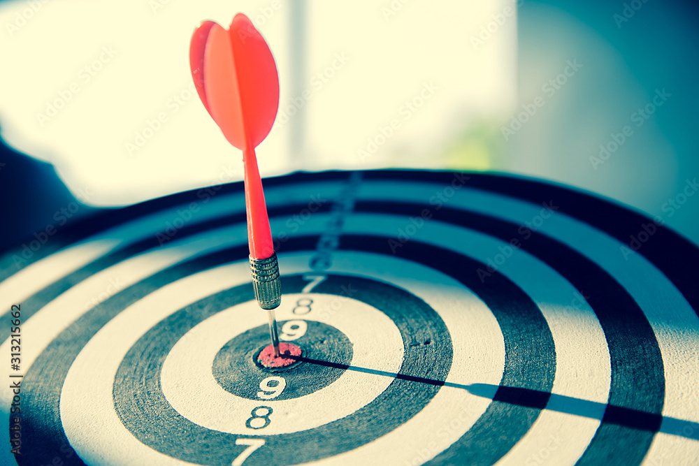 Close up red color arrow in the center of Bullseye concept of business goal and capability. Close up red color arrow in the center of Bullseye concept of business goal and capability.