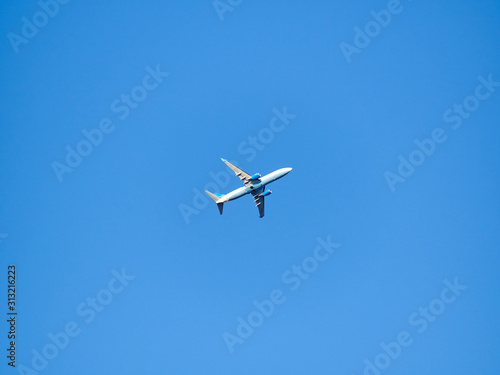Alone plane in blue day sunny sky minimalism background