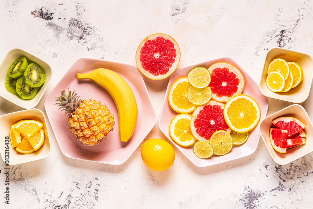 Tropical fruits whole and slices on plates Tropical fruits whole and slices on plates