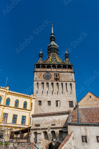 The clock tower in old town of Sighisoara afternoon during spring season . One of the most impotant tower . Also Sighisoara is Unesco sites of the country , Sighisoara , Transylvania , Romania