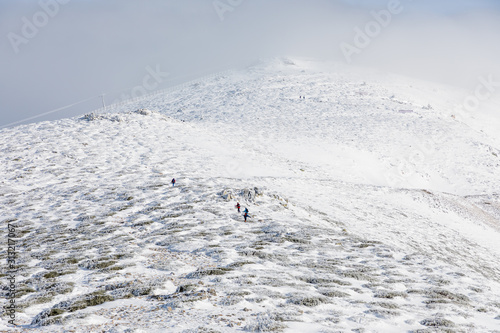 mountaineers climbing to the top of the mountain of Madrid known as Guarramillas in Madrid photo