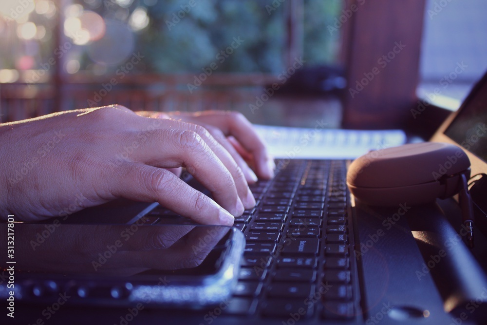 hands typing on laptop keyboard hands typing on laptop keyboard