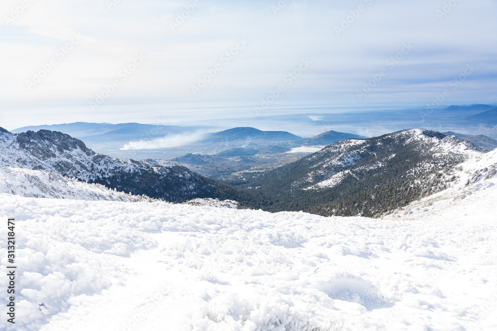 Snowy mountains in the Sierra de Guadarrama of Madrid seen from the ascent to Guarramillas