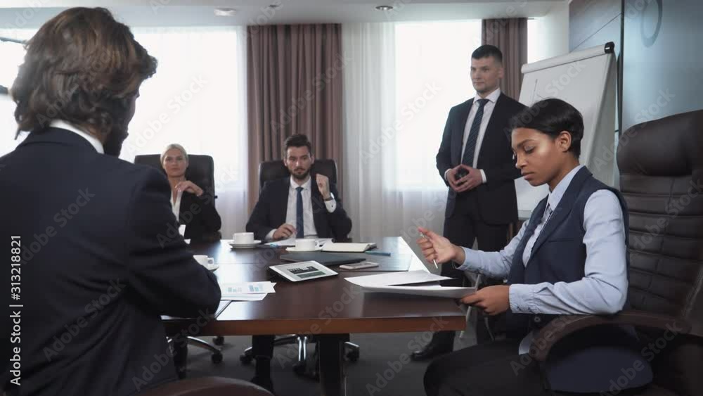international business meeting, the process of signing a contract between businessmen, man and woman, registration of contract papers, handshake, team of financiers in the background. international business meeting, the process of signing a contract between businessmen, man and woman, registration of contract papers, handshake, team of financiers in the background.