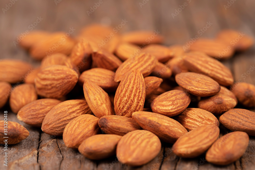 Almonds on old wooden table background Almonds on old wooden table background