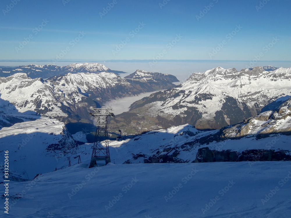 Naklejka premium Winter landscape from mount Titlis over Engelberg on Switzerland