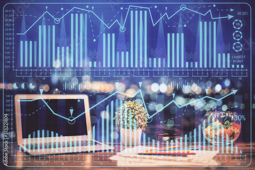 Forex graph hologram on table with computer background. Double exposure. Concept of financial markets. © peshkova