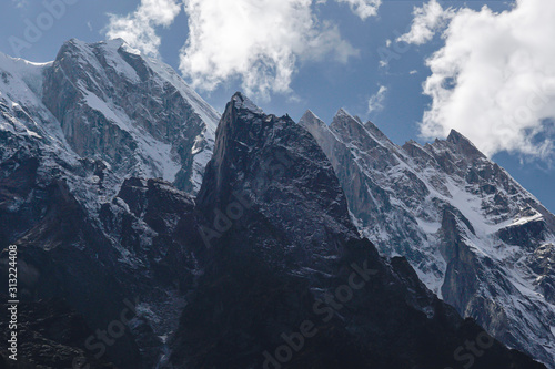 Gangotri National Sanctuary  Uttarakhand  India  snow covered mountain with blue sky and clouds on the way to Gaumukh  the spiritual source of the river Ganges