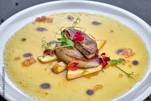 Foie gras with sauce, on a white plate photo