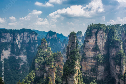  Top view of amazing natural quartz sandstone pillars of fantastic shapes among green woods in the Tianzi Mountains Avatar Mountains, the Zhangjiajie National Forest Park, Hunan Province, China.