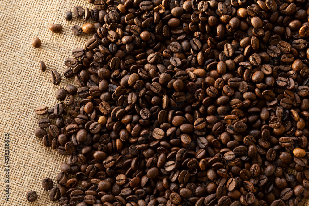 Structured linen background with roasted coffee beans