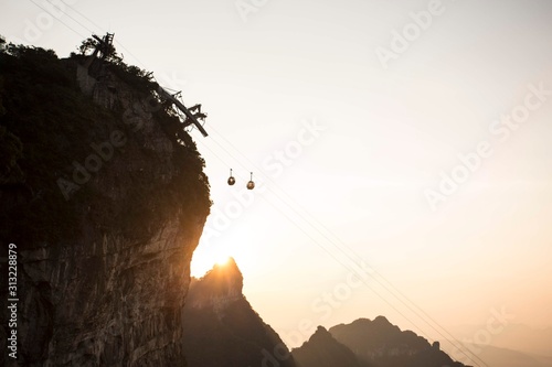 Cable car above winding road in Tianmen mountain, China. photo