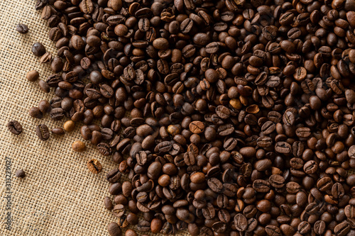 Structured linen background with roasted coffee beans