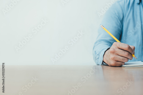 high school,university student study.hands holding pencil writing paper answer sheet.sitting lecture chair taking final exam attending in examination classroom.concept scholarship for education abroad