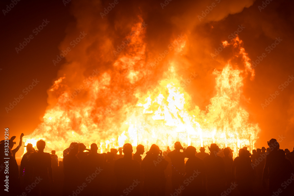 Bonfire inferno burning in front of people