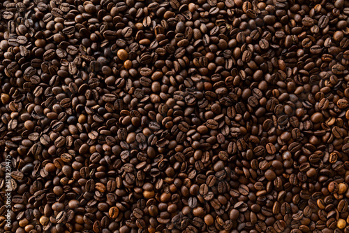 Background filled with a lot roasted coffee beans