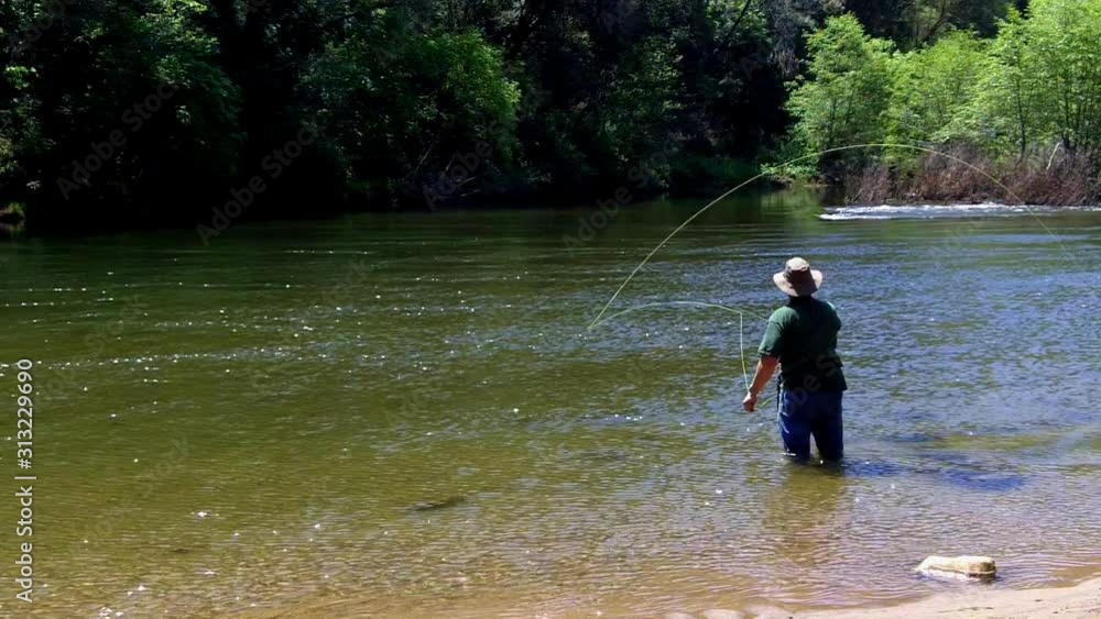 Man Fly Fishing In Sierra Nevada Mountain River Man Fly Fishing In Sierra Nevada Mountain River
