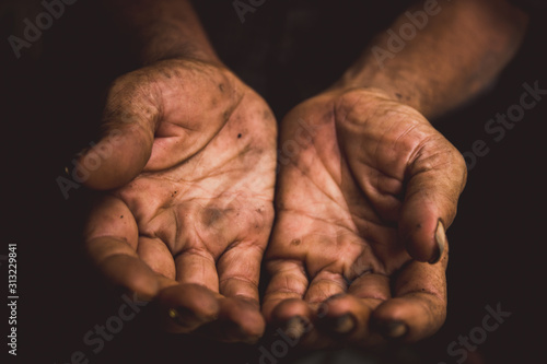 hands poor man or beggar begging you for help sitting at dirty slum. concept for poverty or hunger people,human rights,donate and charity for underprivileged people in third world