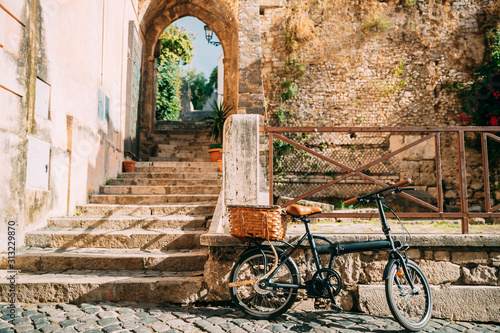 Fototapeta Naklejka Na Ścianę i Meble -  Terracina, Italy. Single Bicycle Bike With Basket Parking On Street Near Old Building