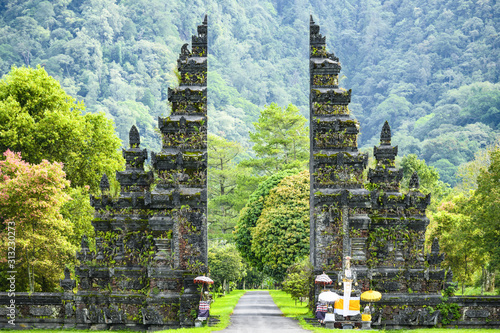 Stunning view of the Handara Iconic Gate located in North Bali, Indonesia. The Hindu gate symbolises the entrance from the outer world to the temple and today is one of the most iconic Bali photos.